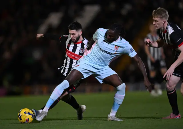 Géza Dávid Turi of Grimsby Town and Omari Patrick of Tranmere Rovers