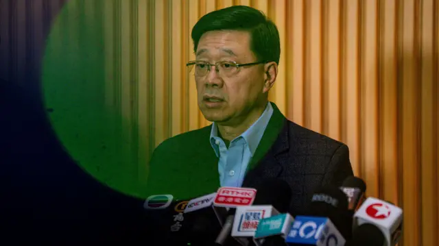 John lee speaking at press conference