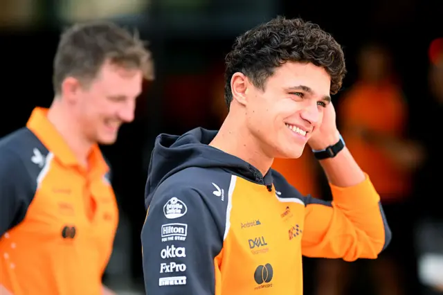 Lando Norris arrives in the paddock in Qatar