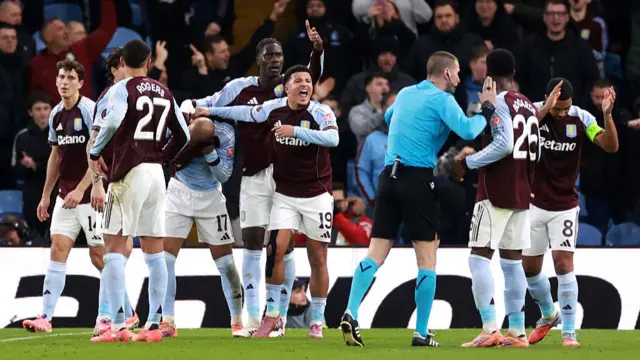 Aston Villa players protest to referee Georgi Kabakov after a plastic cup was thrown