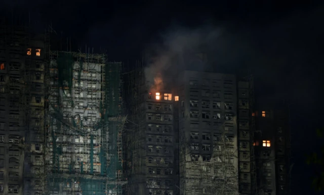 Smoke rises as a deadly fire, which broke out yesterday, continues to burn at Wang Fuk Court housing comple