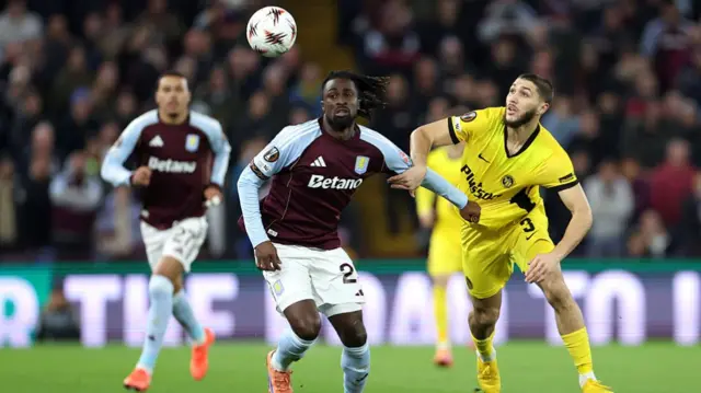 Evann Guessand of Aston Villa battles for possession with Jaouen Hadjam of Young Boys