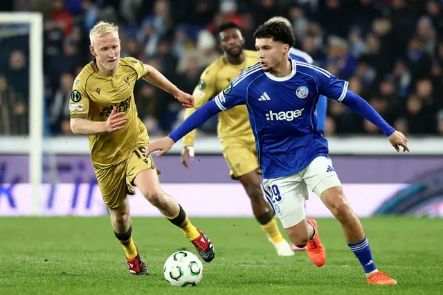 Samir El Mourabet (R) fights for the ball with Will Hughes (L)
