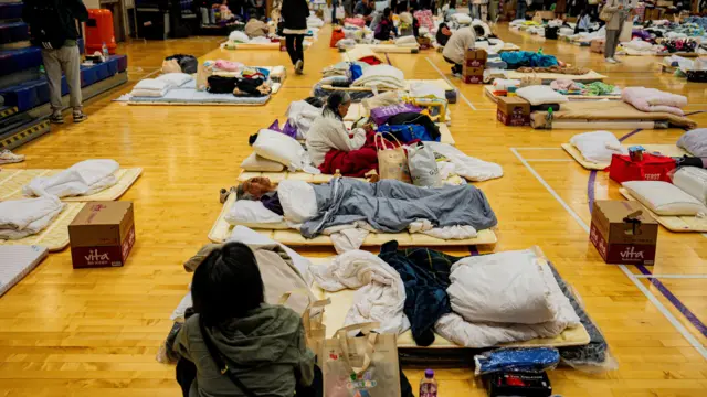 Image showing people sheltering in a community hall acting as an emergency shelter after the apartment fire in the Tai Po