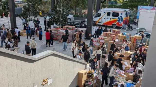 Street is full of volunteers organising donations for those impacted