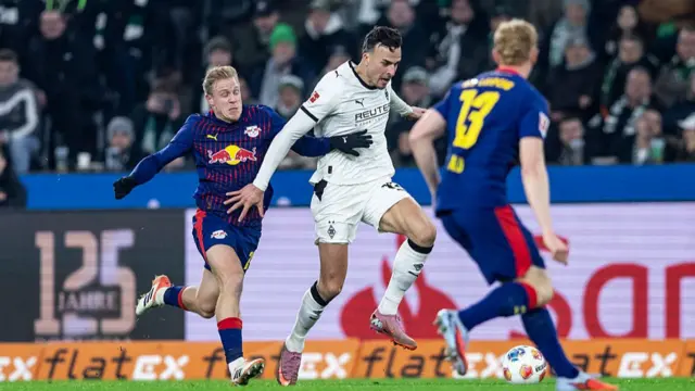 Haris Tabakovic of Borussia Moenchengladbach and Xaver Schlager of RB Leipzig battle for the ball