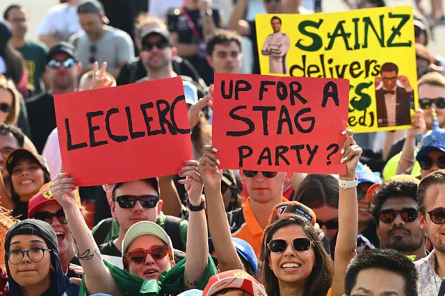 Fans hold up sings in Qatar