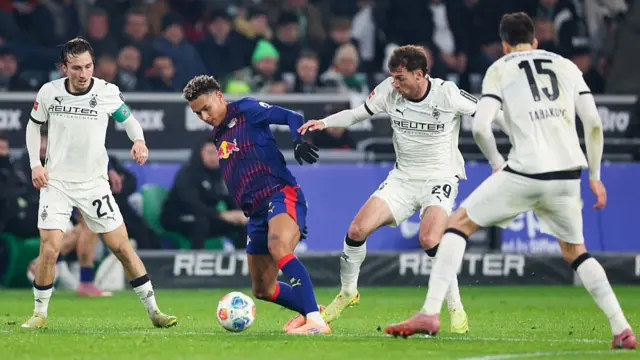 Antonio Nusa of RB Leipzig battles for the ball with Rocco Reitz