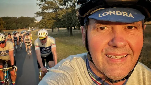 Martin Casson takes of selfie while riding a bike