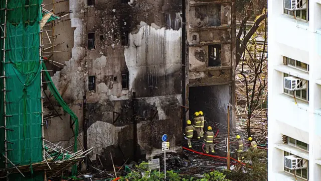 Firefighters at one of the towers following a fire at the Wang Fuk Court residential estate in Tai Po district in Hong Kong