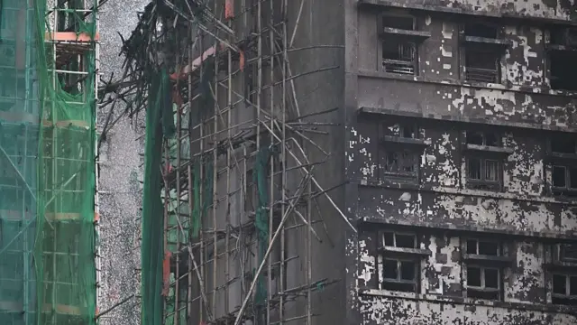 Damaged buildings are seen in the aftermath of a major fire that swept through several apartment blocks at the Wang Fuk Court residential estate in Hong Kong's Tai Po district on November 28, 2025.