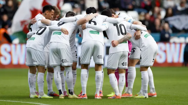 Swansea players in a pre-match huddle