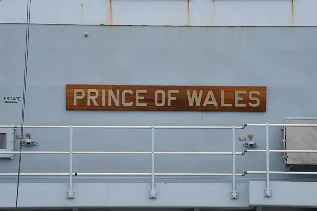 The logo of British aircraft carrier HMS Prince of Wales is seen while docking at the Tokyo International Cruise Terminal in Tokyo on August 28, 2025