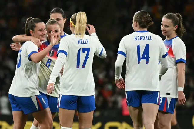 England's midfielder #10 Ella Toone (L) celebrates scoring the team's seventh goal with teammates during the women's International football friendly match between England and China at Wembley Stadium in London on November 29, 2025.