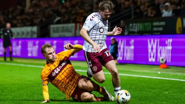 Alan Forrest battles for possession