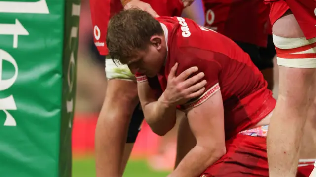 Jac Morgan holds his shoulder