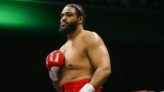 Jeamie TKV holds up his boxing glove