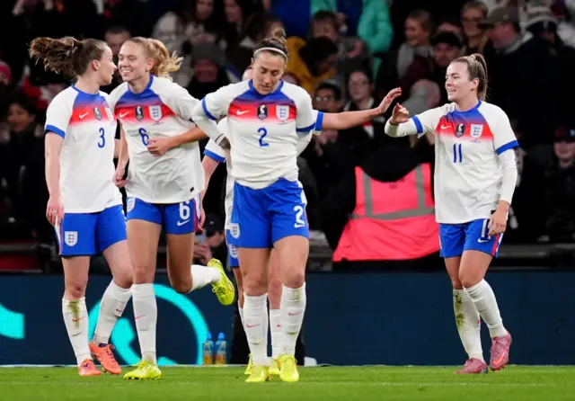 England's Lauren Hemp (right) celebrates with team-mates after scoring their side's third goal of the game during the women's international friendly match at Wembley Stadium, London