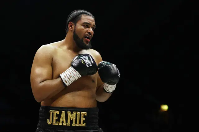 Jeamie TKV is wearing boxing gloves and holds up his hands
