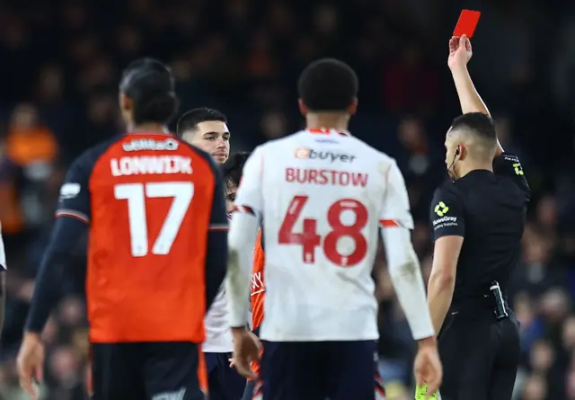 Xavier Simons is shown a red card for Bolton at Luton