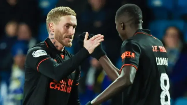 Dundee United's Craig Sibbald celebrates with Panutche Camara