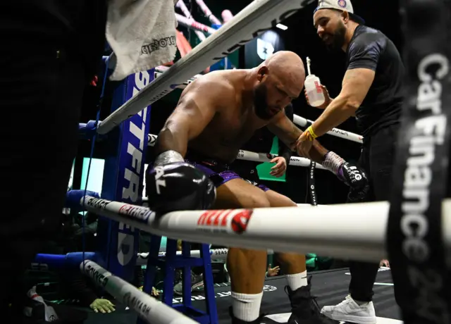 Frazer Clarke crouches over in the corner of a boxing ring