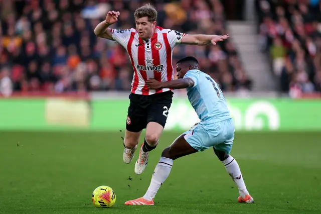 Nathan Collins of Brentford is challenged by Floretino Luis of Burnley