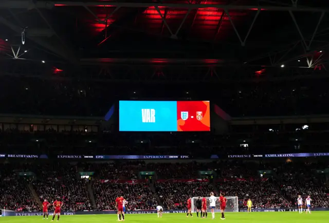 A notice of a VAR check on the big screen during the women's international friendly match at Wembley Stadium, London.