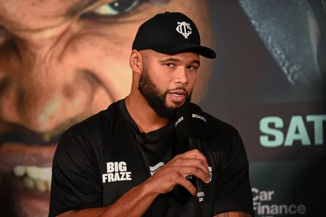 Frazer Clarke speaks into a microphone