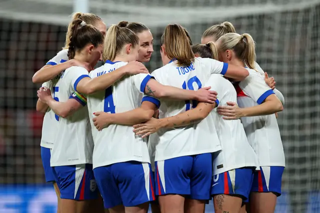 Georgia Stanway of England (partially blocked) celebrates with her teammates after scoring her team's fifth goal from the penalty spot during the Women's international friendly match between England and China PR at Wembley Stadium on November 29, 2025 in London, England.