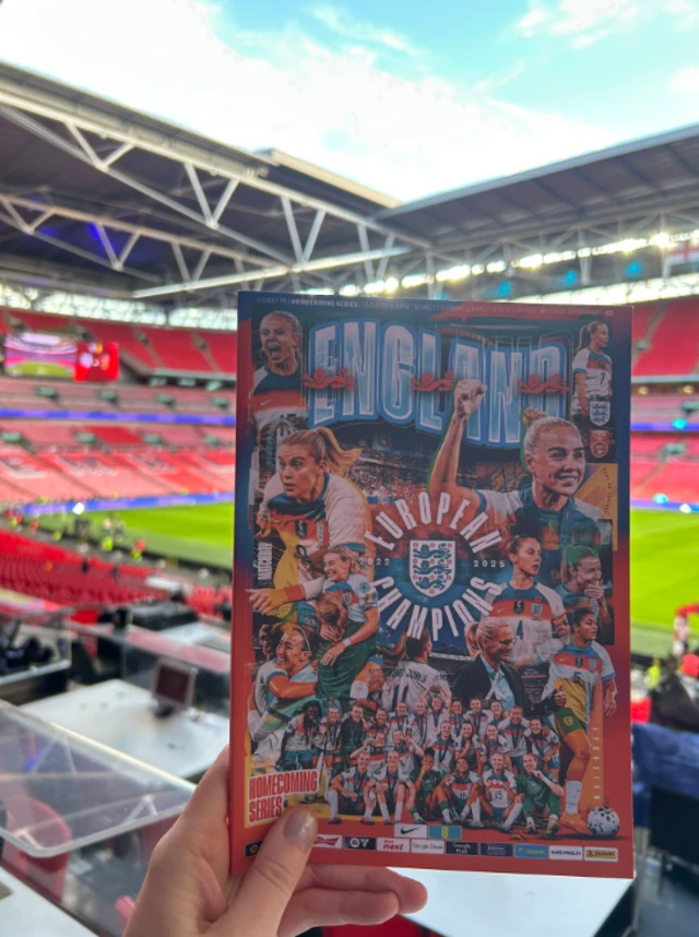 Wembley Stadium with the programme cover