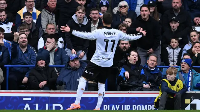 Anis Mehmeti celebrates in front of the Portsmouth fans