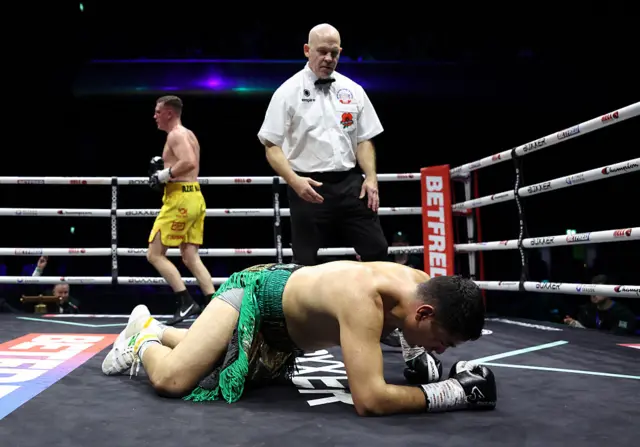 Ivan Gabriel Garcia on the canvas after being knocked down by Jack Massey