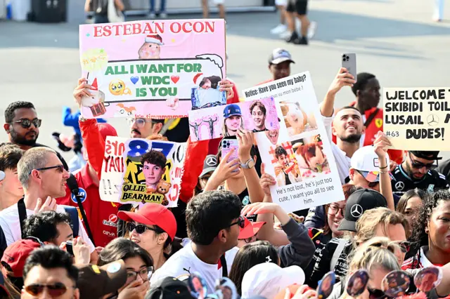 Fans hold up sings in Qatar