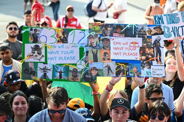Fans hold up signs in Qatar