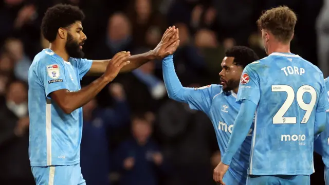 Coventry goalscorer Ellis Simms is congratulated by team-mate Jay Dasilva