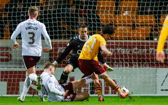 Motherwell's Elijah Just has a shot saved by Hearts' Alexander Schwolow