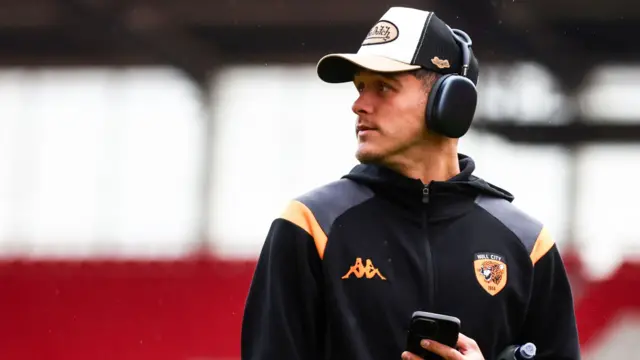 Hull's Ryan Giles holds his phone