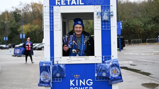 A programme seller outside Leicester's King Power Stadium