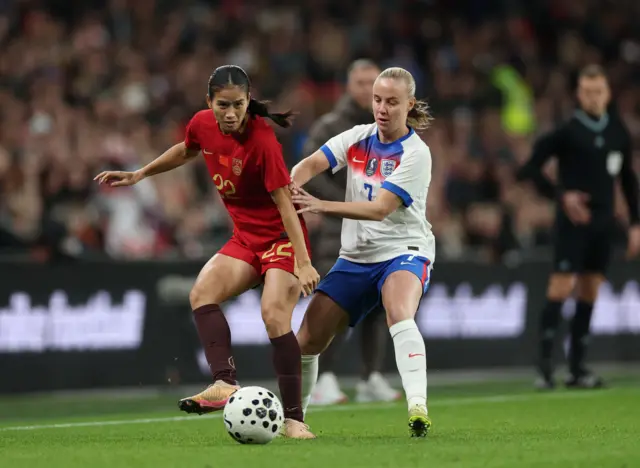 China's Qiaozhu Chen in action with England's Beth Mead