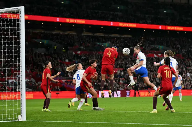 Maya Le Tissier attempts a header at goal from a corner during the women's International football friendly match between England and China at Wembley Stadium in London on November 29, 2025.