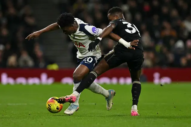Ryan Sessegnon (R) tackles Mohammed Kudus (L)