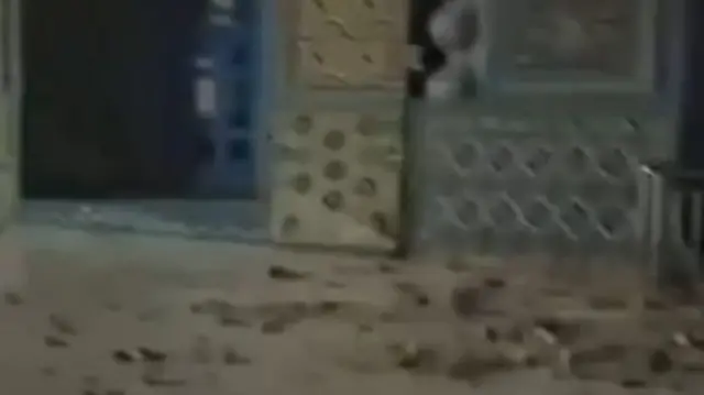 A screengrab from footage showing debris on the ground at the mosque after the earthquake