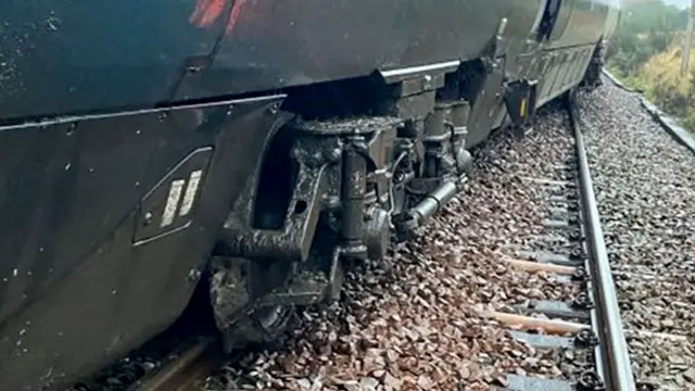The picture appears to show a derailed train sitting across multiple tracks