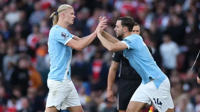 Erling Haaland high-fives Nico Gonzalez