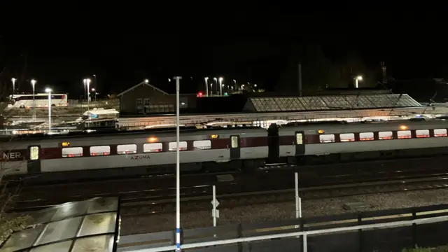 The train is held on the platform, shrouded in darkness