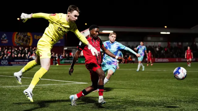 Leyton Orient's Killian Cahill punches the ball clear from Tamworth's Beck-Ray Enoru.