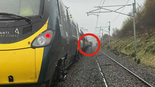 The passenger train that derailed near Shap in Cumbria on Monday morning, with a red circle showing the end of the train that went off the rails.
