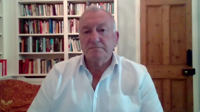 Andy Trotter looks to camera as he speaks to the BBC