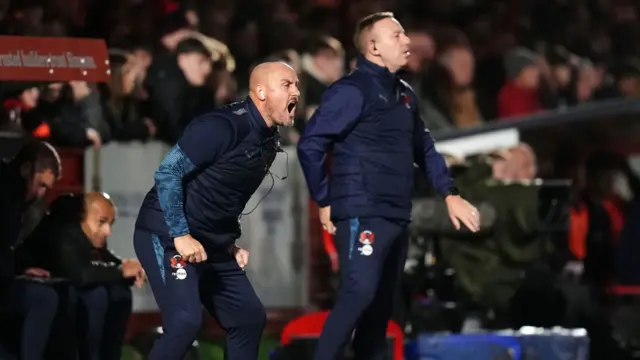 Leyton Orient coaches Alan McCormack and Paul Terry shout from the sidelines
